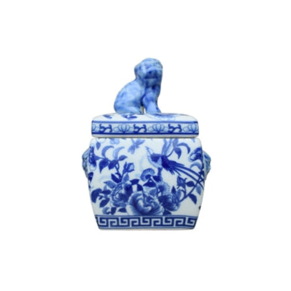 Blue and white ceramic jar with lid featuring a lion design on a white background